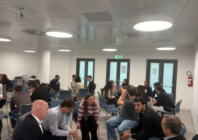 The picture shows groups of people sitting in circles. They are talking to each other.